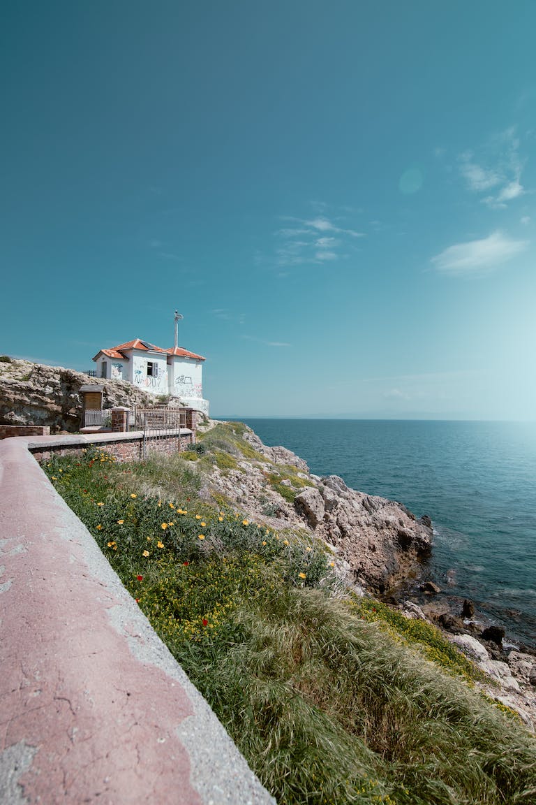 A lighthouse on the coast of a rocky cliff
